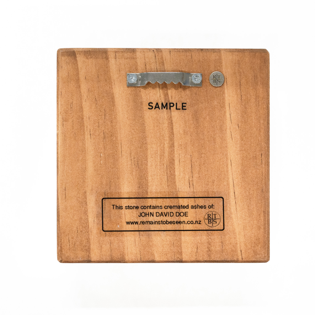 The back of a wooden memorial board showing the authenticity ID label